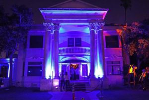 front of house lit up in neon purple colors